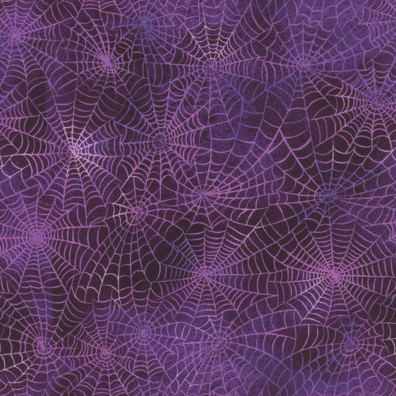 Mottled purple fabric with light spider webs all over.