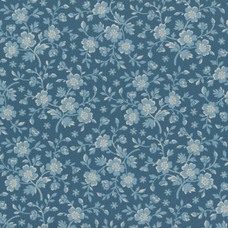 Blue fabric with light blue flowers and leaves with yellow accents.