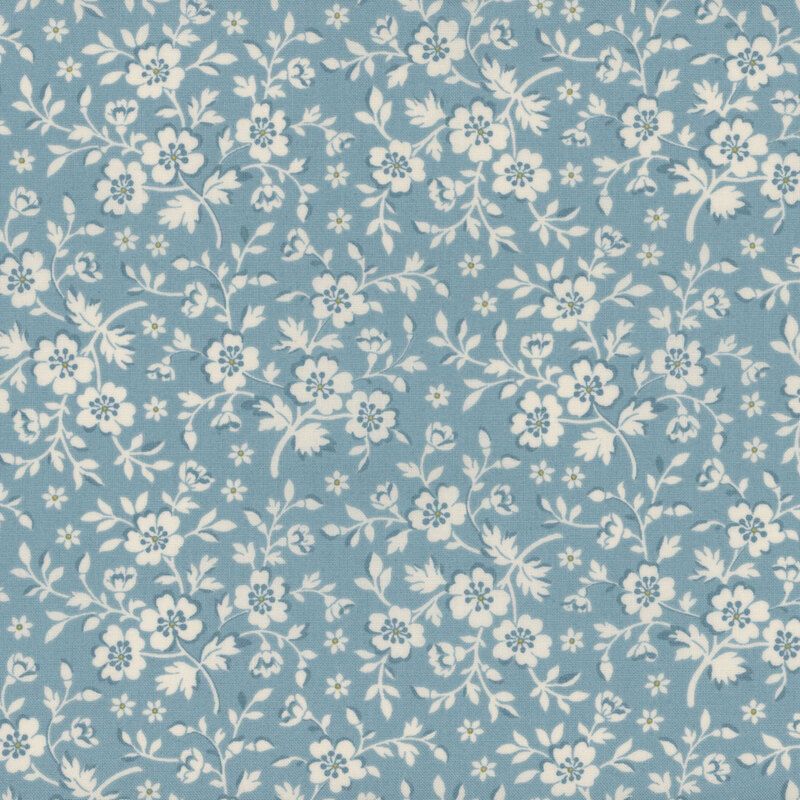 Light blue fabric with cream-colored flowers and leaves with yellow accents.