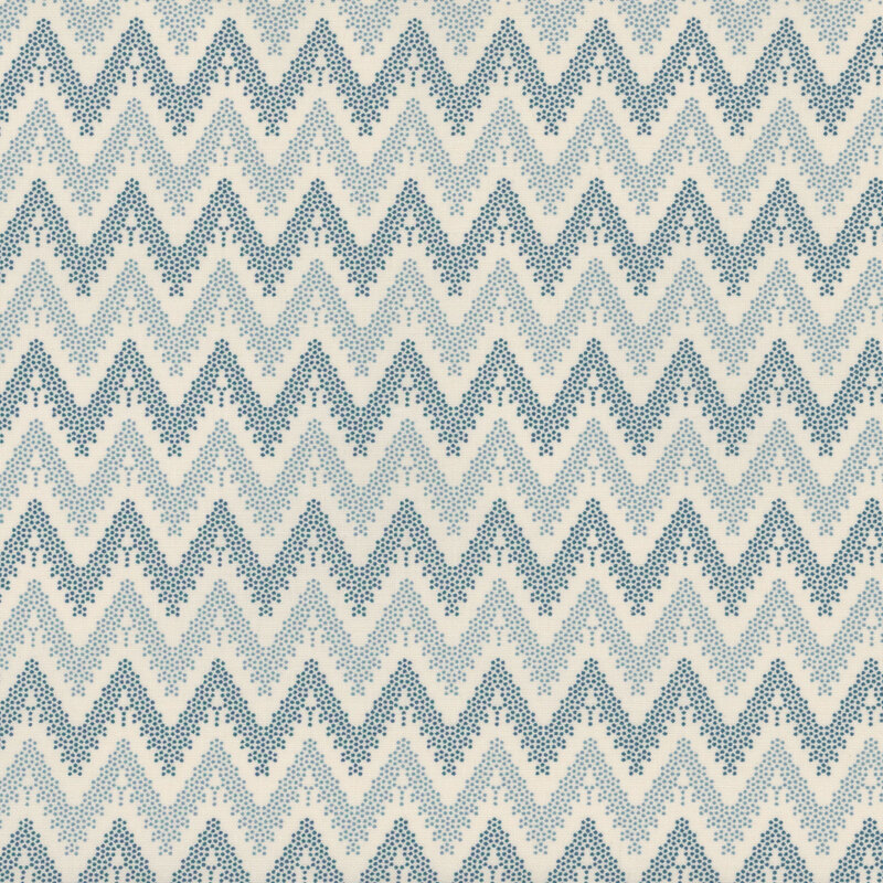 Cream-colored fabric with dotted chevron stripes of blue and navy.