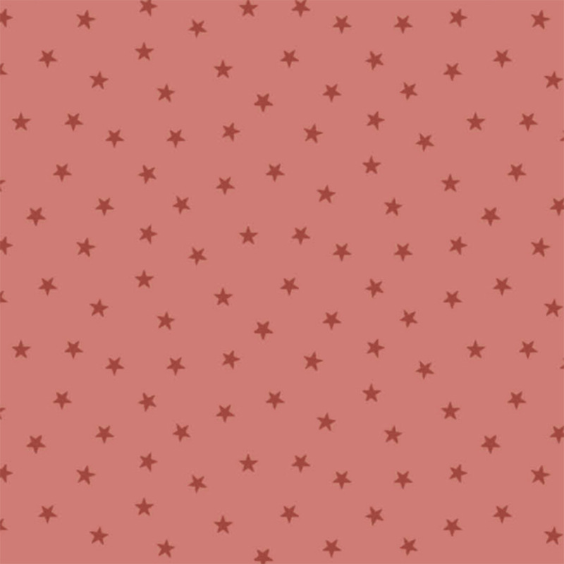 Salmon pink fabric with a pattern of tiny stars in a row
