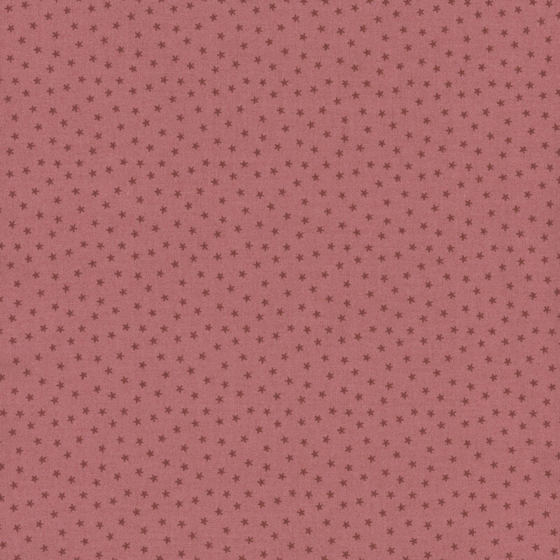 Mauve pink fabric with a pattern of tiny stars in a row