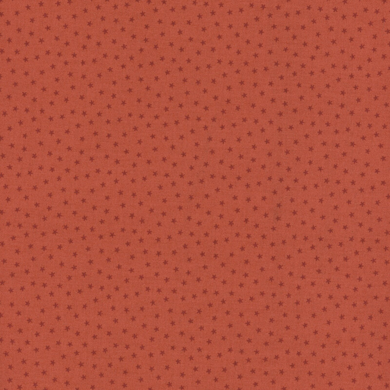 Coral orange fabric with a pattern of tiny stars in a row
