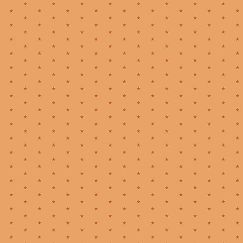 Pastel orange fabric with a pattern of tiny stars in a row