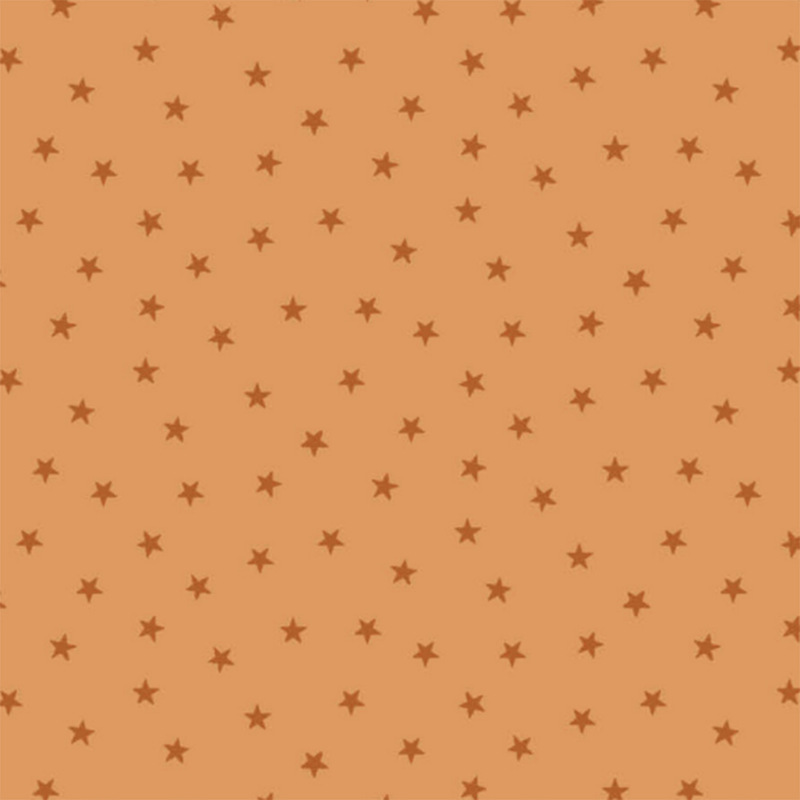 Pastel orange fabric with a pattern of tiny stars in a row