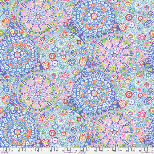 Fabric featuring vibrant multicolor kaleidoscopic abstract designs, shaped around circles.