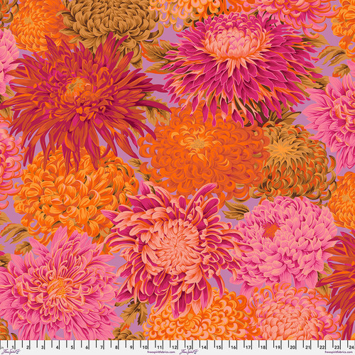 Fabric featuring vibrant pink, magenta, and vermillion chrysanthemums over a light purple background