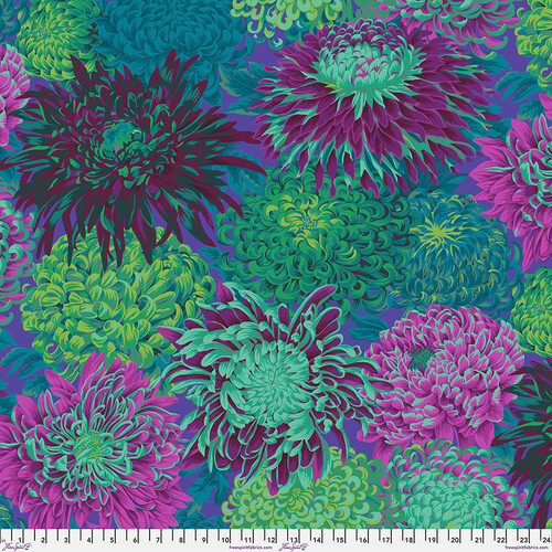 Fabric featuring vibrant purple, green, and teal chrysanthemums over an indigo background