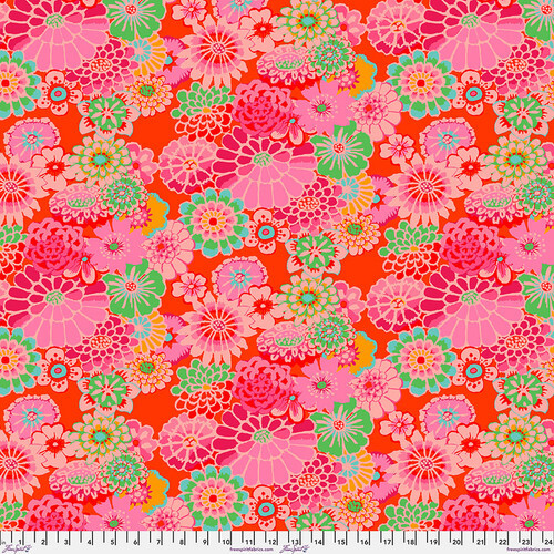 Fabric featuring multicolor modern florals on a tomato red background.