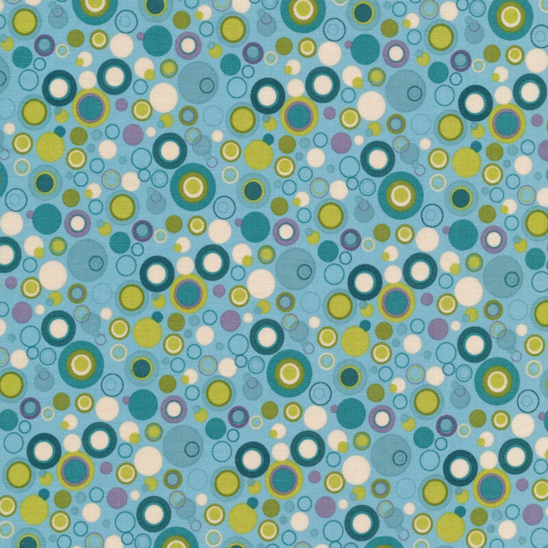 blue fabric with green, teal, purple and white dots that look like bubbles