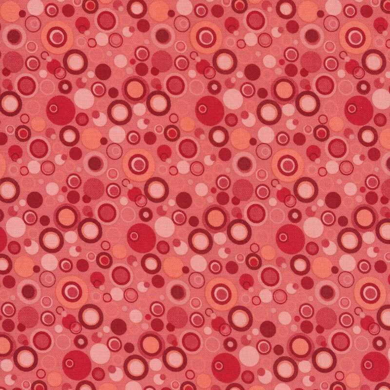 pink fabric with dots that look like bubbles in shades of pink and red
