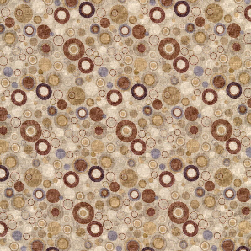 Tan fabric with dots that look like bubbles in gray and shades of brown