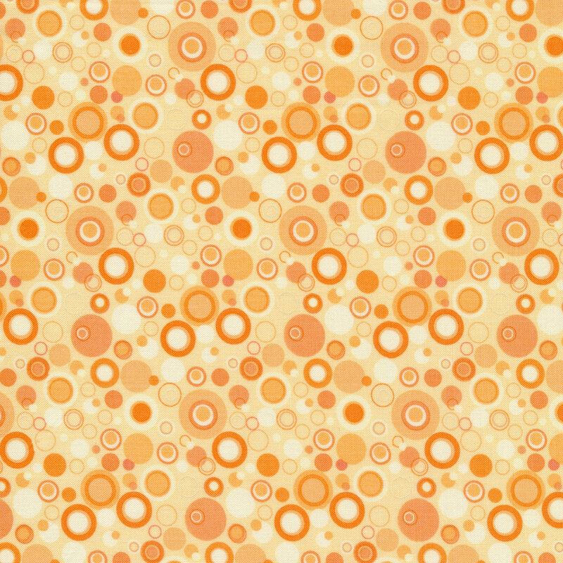Yellow fabric with dots that look like bubbles in shades of yellow and orange