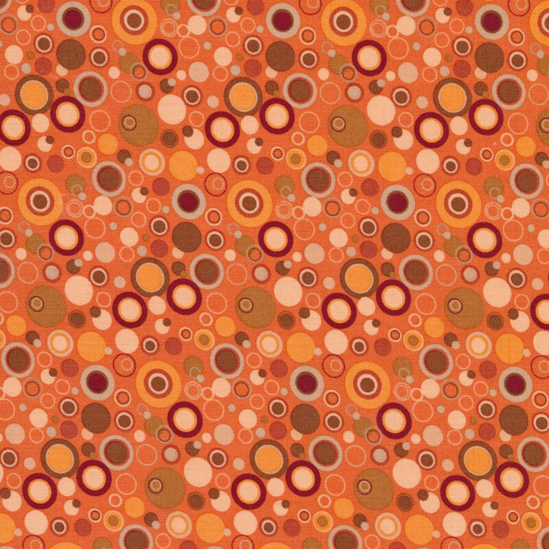 orange fabric with dots that look like bubbles in shades of red orange and brown