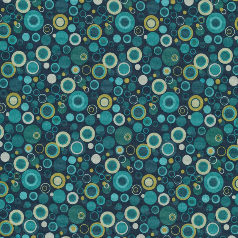 dark blue fabric with dots that look like bubbles in shades of blue, teal, and yellow-green