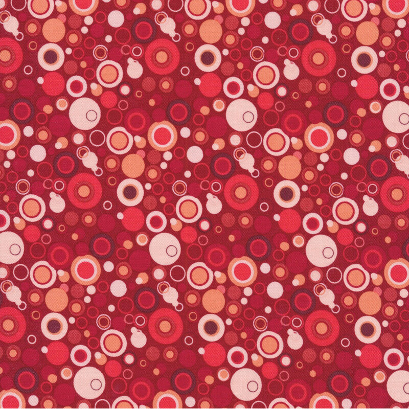 red fabric with dots that look like bubbles in white, and shades of red and pink