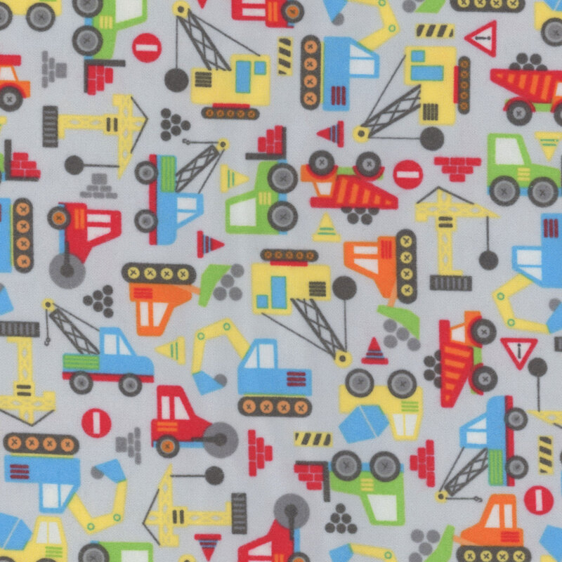 gray fabric featuring colorful construction trucks