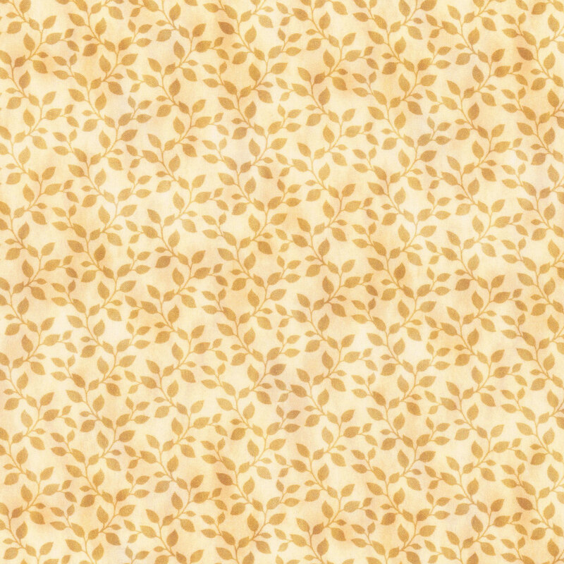 This fabric features golden tonal leaves mottled with the pale, golden yellow background.
