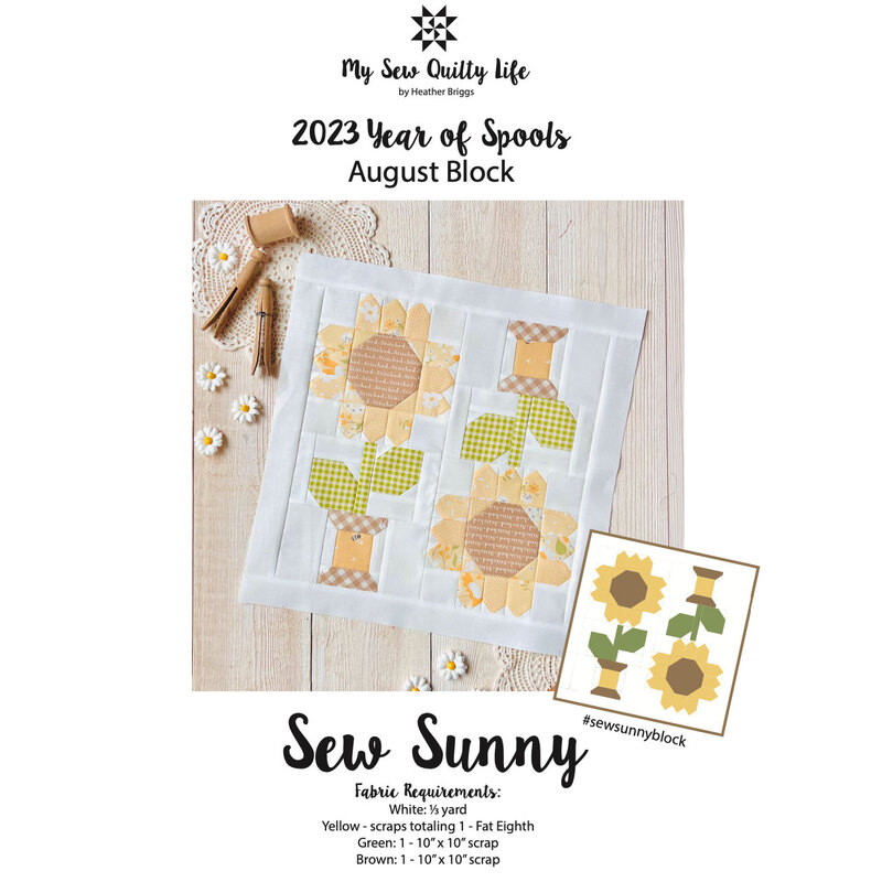 Front cover of the pattern, showing the completed sunflower spool block (without borders or finishing), staged on a rustic wood table with wooden spools and clothes pins on a lace doily, as well as scattered, decorative daisies.