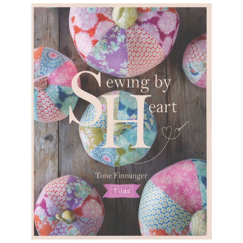 Front cover of the book, showcasing a photograph of several patchwork pumpkins in many colors from a top-down view.