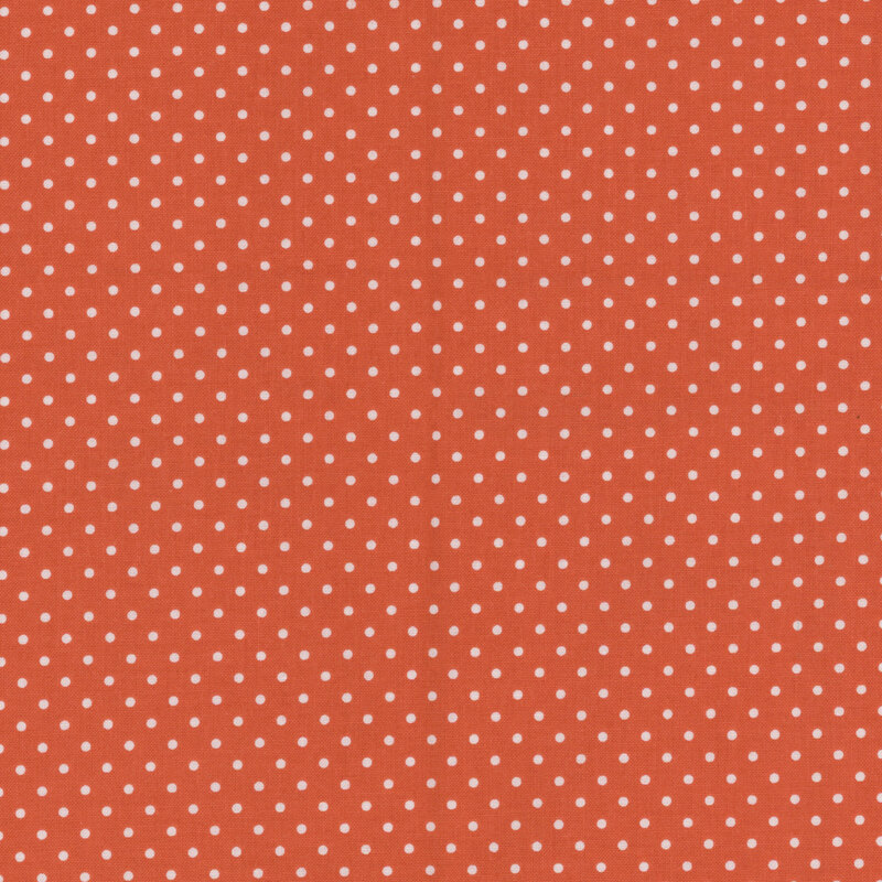 Pumpkin orange fabric with white polka dots.