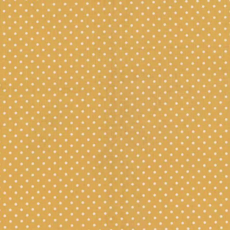 Mustard yellow fabric with white polka dots.