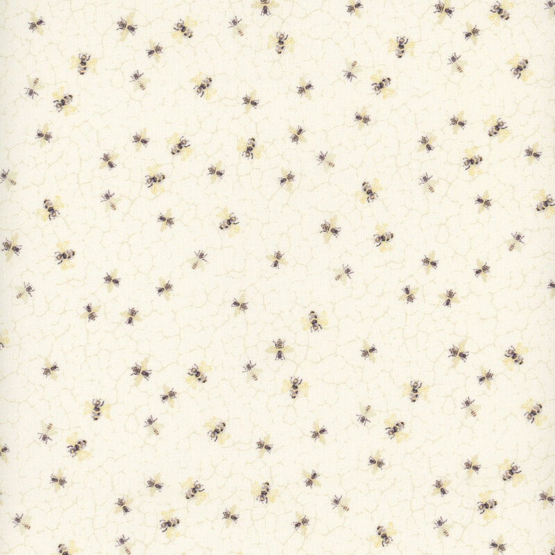 fabric featuring bees on a cream honeycomb-like background