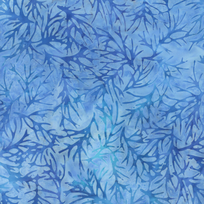 Blue mottled fabric with tossed dark blue branch silhouettes all over