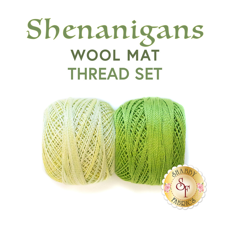 Two spools of thread, one pastel green and one bright grass green, sit side by side on a white background below the text graphics 