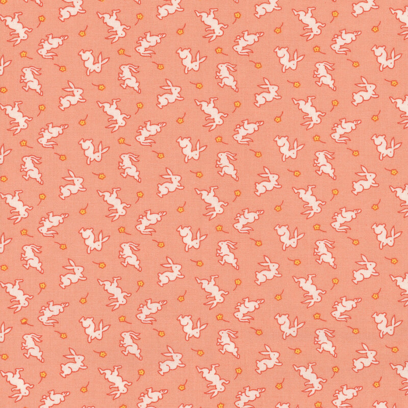 Peach-colored fabric with white bunnies and small yellow daisies.