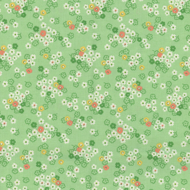 Green fabric with white daisies with yellow and orange accents.
