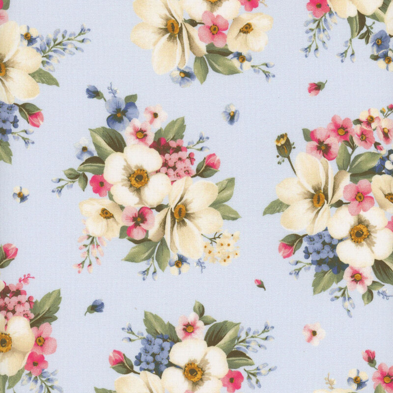 Light blue fabric with white, blue, and pink flowers in clusters with green leaves all over