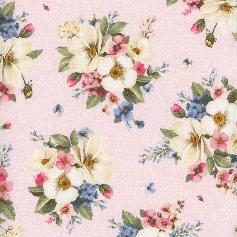 Light pink fabric with white, blue, and pink flowers in clusters with green leaves all over