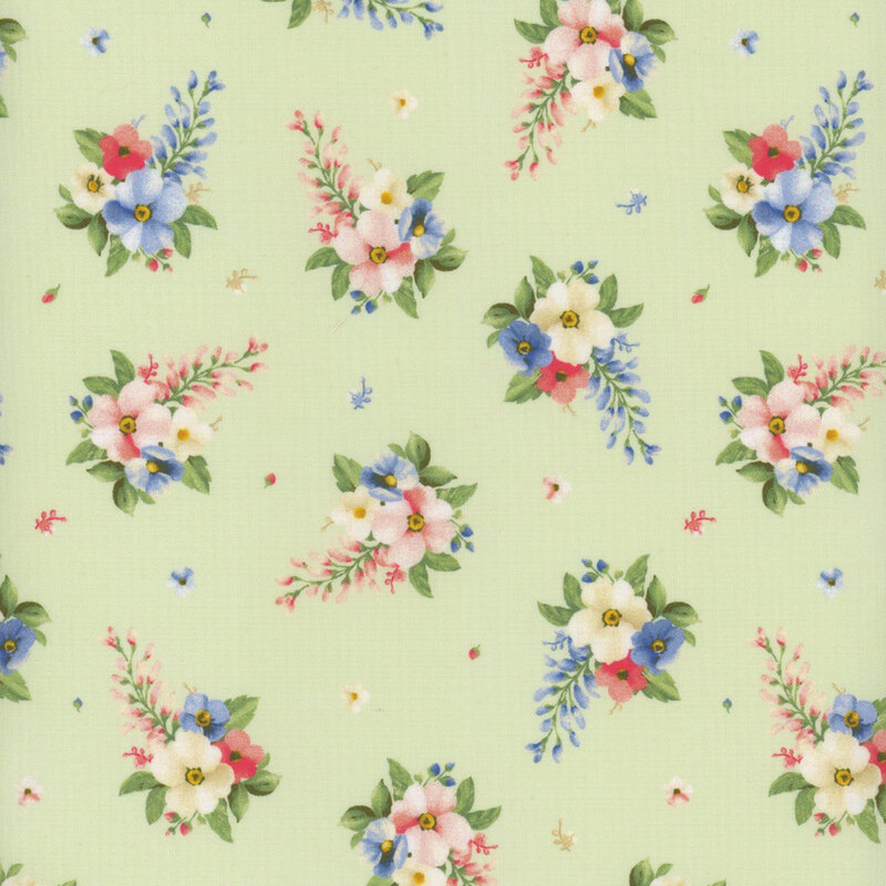 Light green fabric with small clusters of cream, pink, and blue flowers with green leaves all over