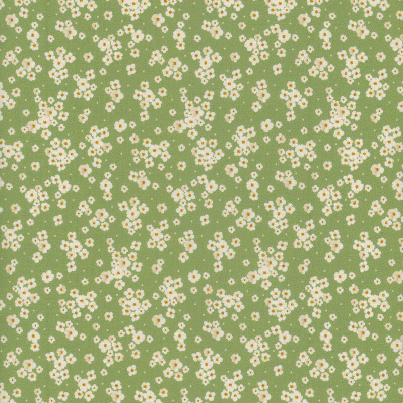 Green fabric featuring tossed small white flowers
