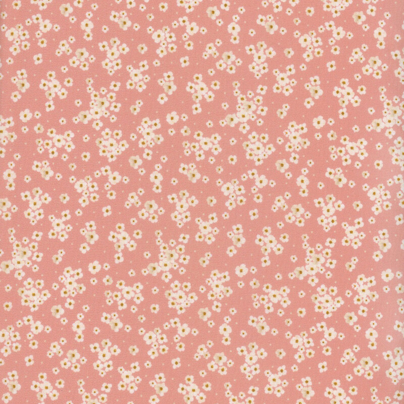 Pink fabric featuring tossed small white flowers