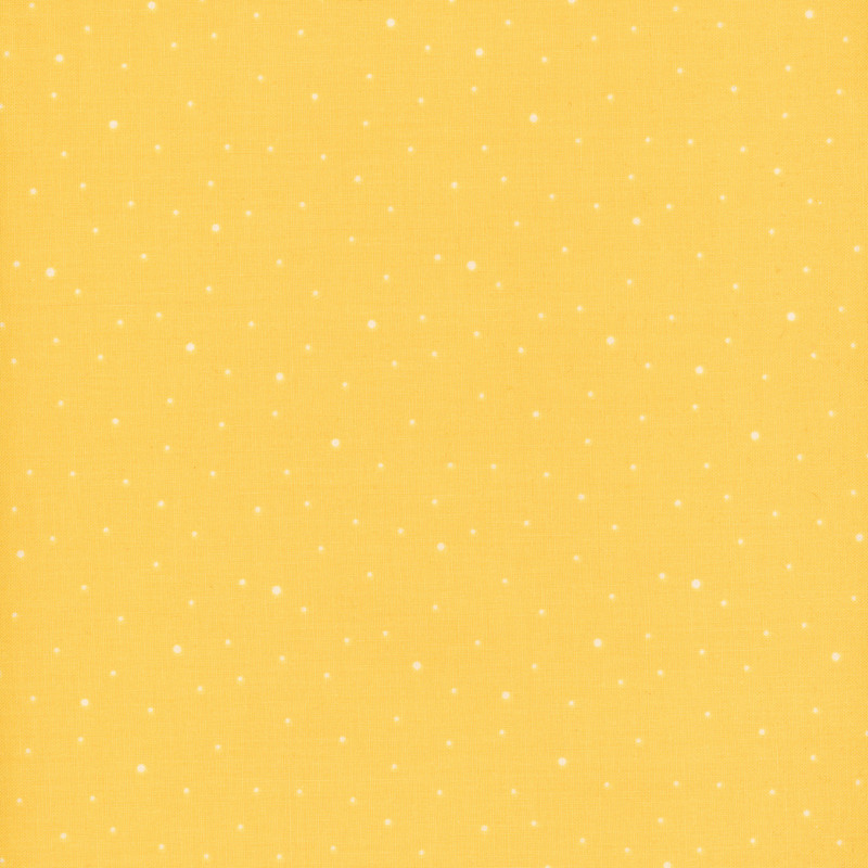 butter yellow fabric with scattered white polka dots
