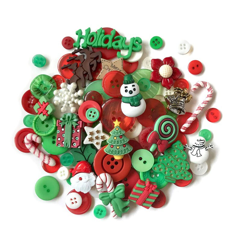 Pile of red green, and white Christmas themed buttons against a white background