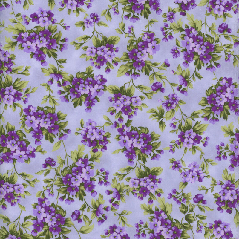 Periwinkle fabric with clusters of small purple flowers.