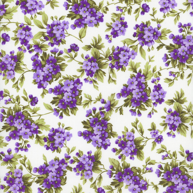 Cream-colored fabric with clusters of small purple flowers.