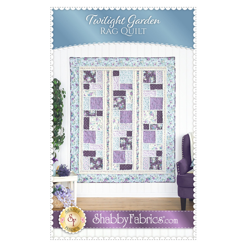 Front cover of the pattern showing the completed quilt in gentle shades of blue, purple, lilac, and cream.