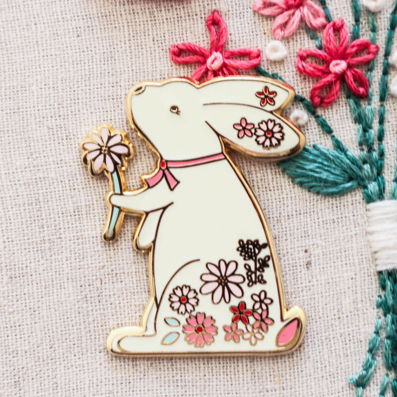 The floral bunny needle miner displayed on a hand embroidery project 