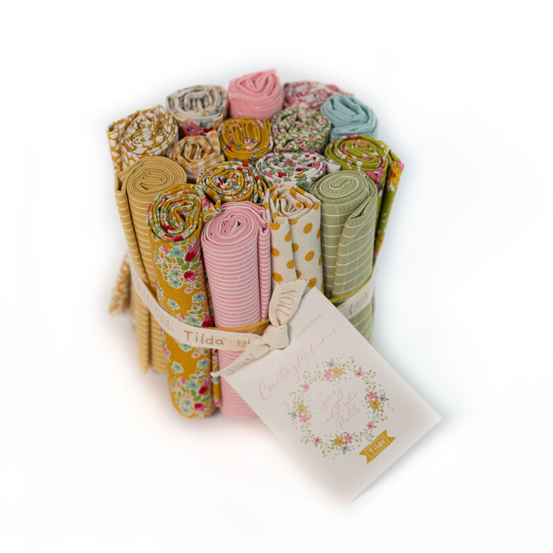 cluster of rolled up Spring fabrics in the Creating Memories fat eighth set