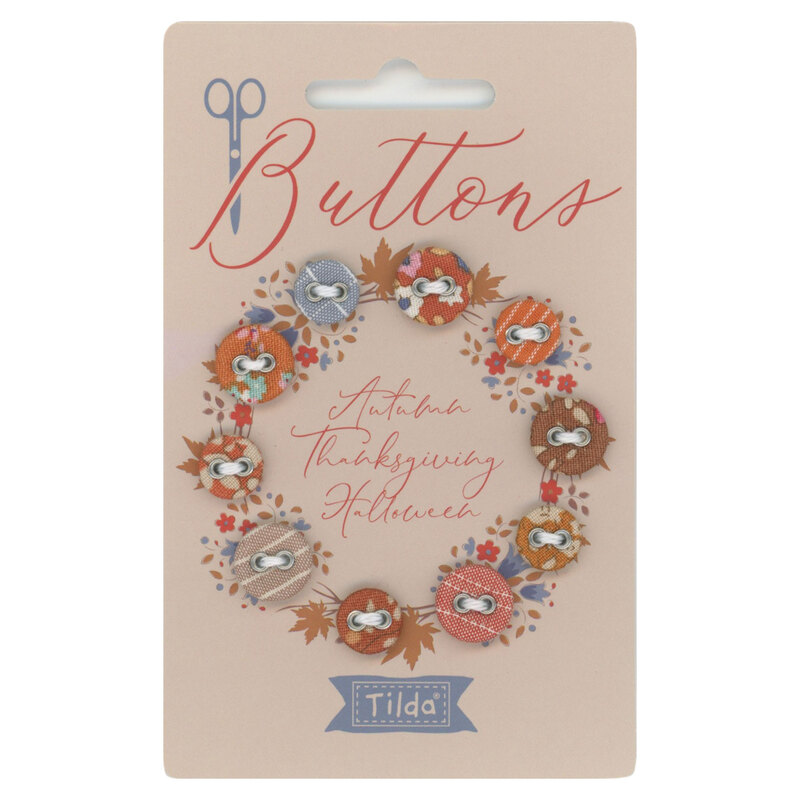 a card with Autumn Thanksgiving Halloween fabric covered buttons arranged in a circle
