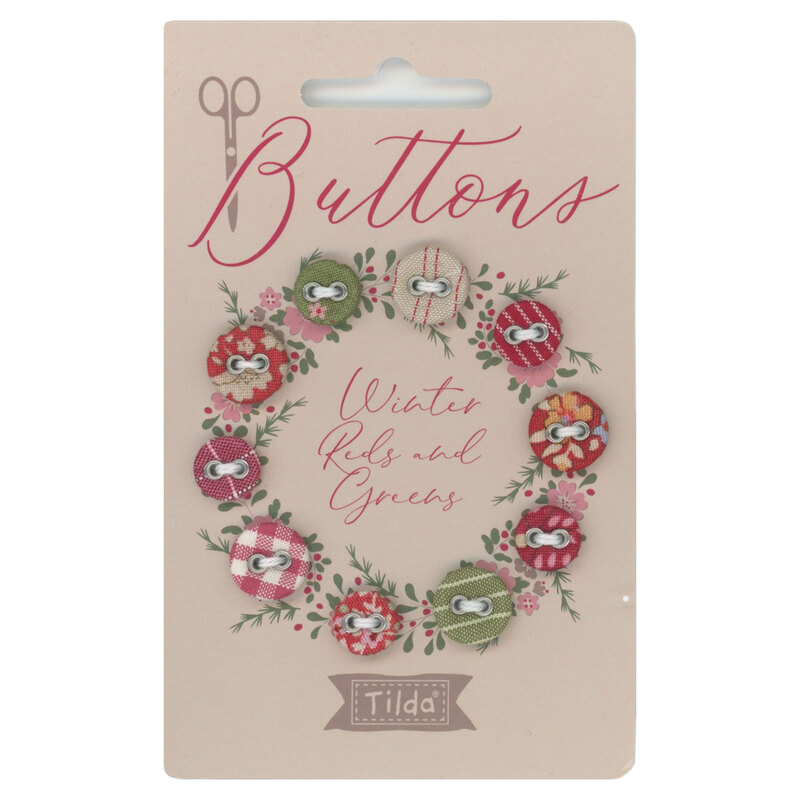 a card with Winter Reds and Greens fabric covered buttons arranged in a circle