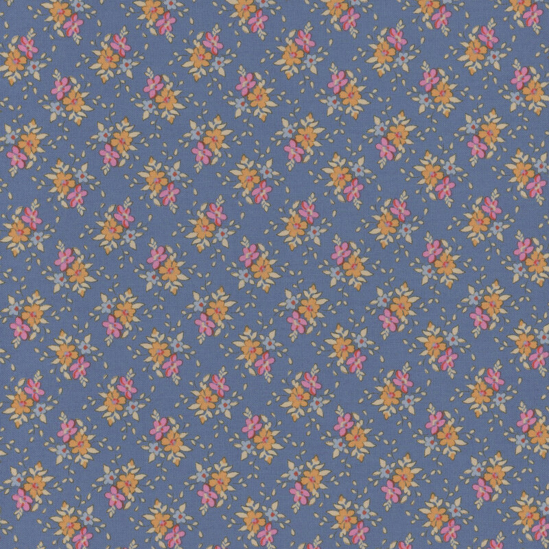 Blue fabric with clusters of pink, orange and blue flowers with green leaves