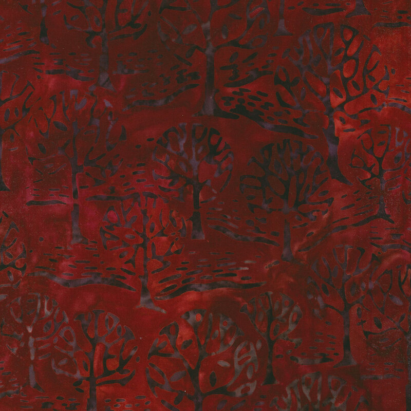 Red mottled fabric with a forest of mottled black trees.