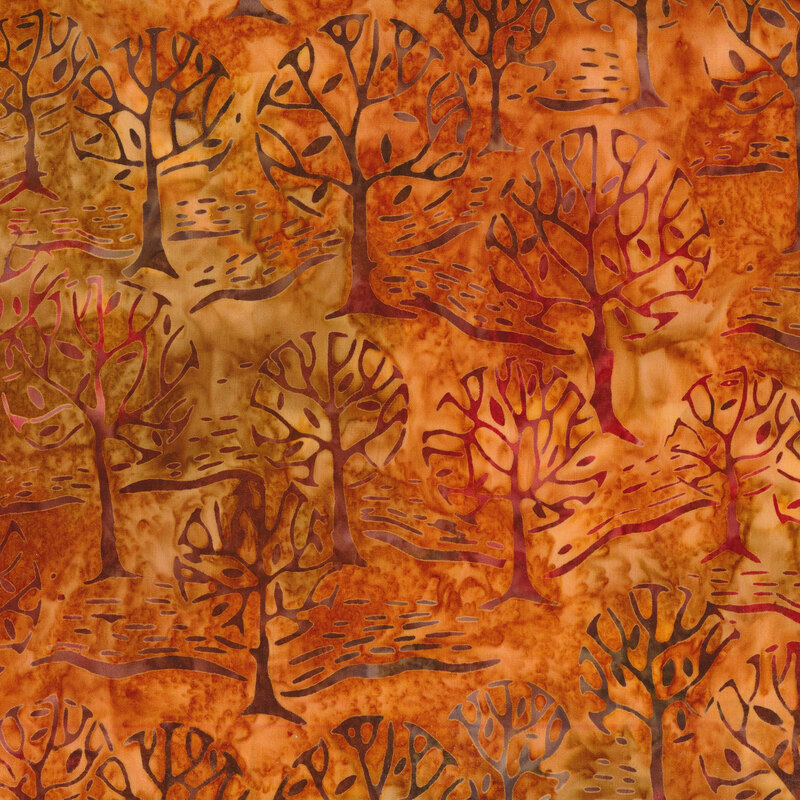 Orange mottled fabric with a forest of mottled brown trees.