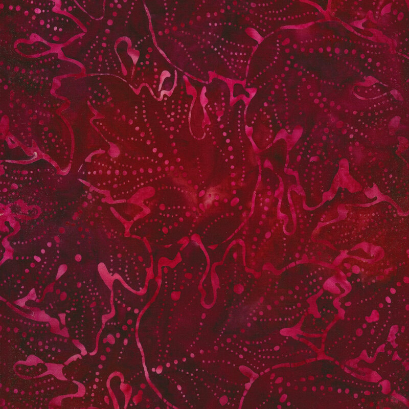 Maroon mottled fabric with a random pattern of swirls and dots.