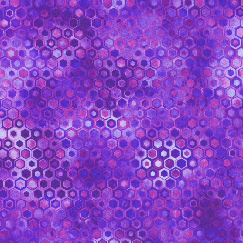 beautifully mottled geometric fabric featuring a honeycomb pattern filled with nestled hexagons in varied shades of vibrant purple, fuchsia, and blue